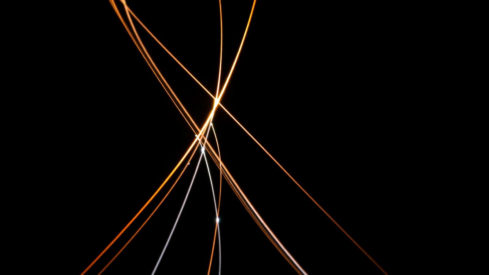 Long-exposure photograph of fibre-optic light trails converging on a single point